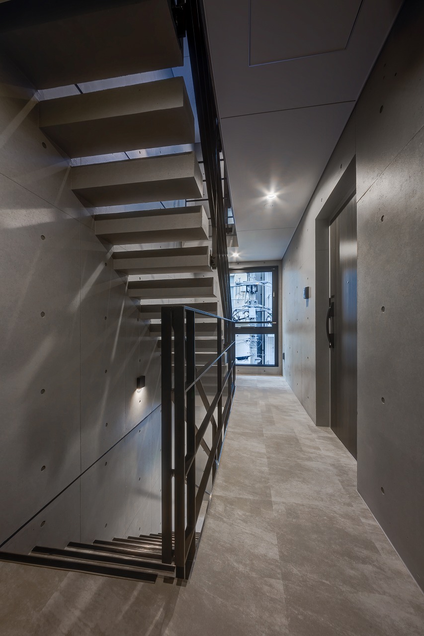 上階から光が落ちる、抜けのある共用階段